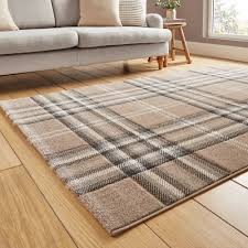 Checked area rug on a wooden floor beside a sofa