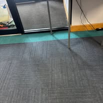 Carpet tiles around an entrance mat