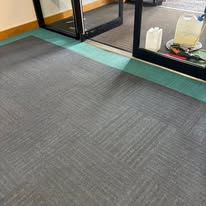 Grey carpet tiles at a commercial entrance